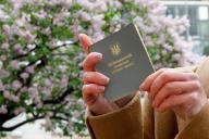 KYIV, UKRAINE - APRIL 17, 2024 - A woman holds a Ukrainian military ID card of the reserve officer, Kyiv, capital of Ukraine., Credit:Kirill Chubotin \/ Avalon