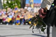 LVIV, UKRAINE - APRIL 28, 2024 - Flowers and willow sprigs are seen in the hand of a participant of the FreeAzov action in support of the military held in Russian captivity, Lviv, western Ukraine., Credit:Anastasiia Smolienko \/ Avalon