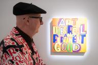 Artist Bob and Roberta Smith (aka Patrick Brill) poses with his painting \'Art Does Real and Permanent Good\' (2022) at Sotheby\'s \'Art for AT THE BUS\' which is to go on online auction between 29th April 2024 - 10th May 2024 and proceeds going to \'AT