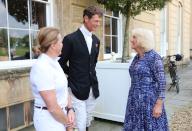 BADMINTON, GLOUCESTERSHIRE - MAY 12: Queen Camilla (R) is greeted by previous winners Pippa Funnell (L) and William Fox-Pitt (C) as she arrives to attend the final day of the Badminton Horse Trials 2024 at Badminton House on May 12, 2024 in 