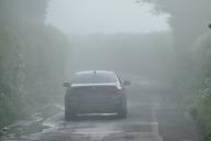 Drivers make their way along the country lanes in the mist., Credit:Geoffrey Swaine / Avalon