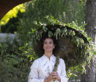 Royal Hospital, Chelsea, London, UK. 20th May, 2024. Press and VIP day at the RHS Chelsea Flower Show 2024 which opens to the public from 21 May-25 May. Image: Game of Thrones actress Indira Varma poses with a floral umbrella on the Water Aid Garden