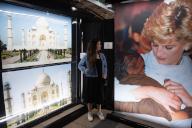 Zak Hussein poses in front of a photo of him with The late Queen Elizabeth II at Dockside Vaults, St Katharine Docks, London, England, UK on Thursday 23 May, 2024 as part of the 