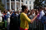 President Barack Obama and First Lady Michelle Obama, along with daughters Malia and Sasha, greet guests during the 2012 White House Easter Egg Roll on the South Lawn, April 9, 2012.