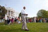 President Barack Obama reacts to the crowd before the start of a race during the 2012 White House Easter Egg Roll on the South Lawn, April 9, 2012.