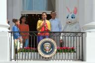 President Barack Obama, along with daughters Sasha and Malia, listen as First Lady Michelle Obama delivers remarks from the South Portico Balcony during the 2012 White House Easter Egg Roll, April 9, 2012.