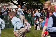 President Barack Obama reacts as children push eggs across the South Lawn during the 2012 White House Easter Egg Roll, April 9, 2012.