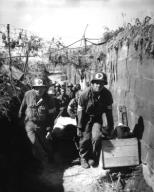 Medics remove a casualty from the battle field to an aid station in an air raid shelter near Brest France formerly used by the Germans. August 28 1944. Gilbert (Army) NARA FILE #: 111-SC-213198 WAR & CONFLICT #: