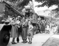 Army Ordnance men await the "go" signal for cross channel trip to France. British civilians serve hot coffee as the men await the word to move out in an English town. July 24 1944. Messerlin. (Army) Exact Date Shot Unknown NARA FILE #: 111-SC-...