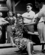 "This girl pays the penalty for having had personal relations with the Germans. Here in the Montelimar area France French civilians shave her head as punishment." Smith August 29 1944. (Edisto Images)