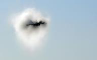 An F/A-18C Hornet aircraft assigned to the "Fist of the Fleet" of Strike Fighter Squadron Two Five breaks the sound barrier while performing a supersonic flyby during an air power demonstration over USS Ronald Reagan (CVN 76) April 3 2007. The ...