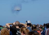 A U.S. Navy F/A-18F jet assigned to Strike Fighter Squadron (VFA) 2 performs a supersonic flyby during an air power demonstration for friends and families of Sailors aboard the aircraft carrier USS Abraham Lincoln (CVN 72) during a Tiger Cruise Oct. ...