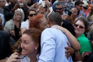 Audience members embrace President Barack Obama after he spoke at the Port of Tampa in Tampa, Fla., April 13, 2012.