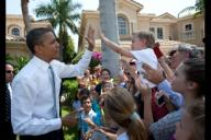 President Barack Obama high fives a young boy outside an event in Palm Beach Garden, Fla., April 10, 2012.
