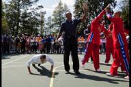 President Barack Obama does push-ups on the White House Basketball Court after a member of the Harlem Globetrotters made a shot, April 9, 2012. The President participated in "Shoot for Strength", a game where children did push-ups for every ...