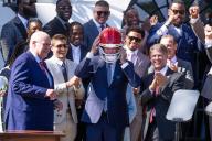 UNITED STATES - MAY 31: President Joe Biden dons a Kansas City Chiefs helmet as head coach Andy Reid, left, and owner Clark Hunt, right, look on, during an event to celebrate the Chiefsâ Super Bowl LVIII championship at the White House on Friday, May 31, 2024. (Tom Williams\/CQ Roll Call