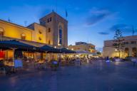 View of cafe and restaurant in Eleftherias Central Square in Kos Town at dusk, Kos, Dodecanese, Greek Islands, Greece, Europe