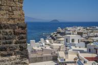 View of sea and whitewashed buildings and rooftops of Mandraki, Mandraki, Nisyros, Dodecanese, Greek Islands, Greece, Europe