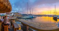 View of golden sunset, boats and restaurants at Knysna Waterfront, Knysna, Western Cape Province, South Africa, Africa