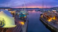 View of boats and restaurants at Knysna Waterfront at dusk, Knysna, Western Cape Province, South Africa, Africa