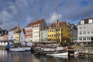 Colourful buildings and tall masted boats on the waterfront at Nyhavn, Nyhavn Canal, Nyhavn, Copenhagen, Denmark, Europe