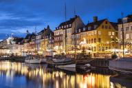 Colourful buildings and tall masted boats on the waterfront at Nyhavn at night, Nyhavn Canal, Nyhavn, Copenhagen, Denmark, Europe