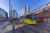 View of apartment buildings, city tram and Tower Of Light, Manchester, Lancashire, England, United Kingdom, Europe