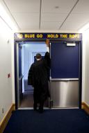 President Barack Obama touches the sign above the locker room door at Michigan Stadium, before giving the commencement address to University of Michigan graduates in Ann Arbor, Mich., May 1, 2010. (Pete Souza/ PSG)
