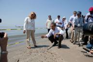 President Barack Obama and Lafourche Parish President Charlotte Randolf, left, inspect a tar ball as they look at the effect the BP oil spill is having on Fourchon Beach in Port Fourchon, La., May 28, 2010. (Chuck Kennedy/ PSG)