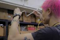 Jive Lau Ho-fai (pink hair) teaches a neon bending workshop to writer Sarah Vega at Kowloneon, a neon workspace in Kwun Tong, Hong Kong, on 19 August 2022. 19AUG22 SCMP / Connor