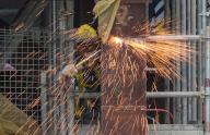 Sparks fly as a worker welds steel at a construction site in West Kowlooon Cultural District. 17APR24. SCMP \/ Eugene