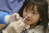Venus Lo, 3-year-old girl, gets vaccinated a free nasal spray influenza vaccination programme for school kids, at Kiangsu Chekiang & Shanghai Medical Centre, North Point. 14JAN24 SCMP/ Dickson