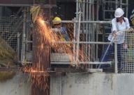 Sparks fly as a worker welds steel at a construction site in West Kowlooon Cultural District. 17APR24. SCMP / Eugene