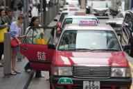 Passengers board taxis in a taxi station at Paterson Street at Causeway Bay. Hong Kong\