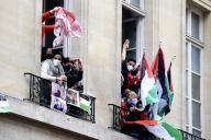 Demonstrators look out of a window with a Palestinian keffiyeh and placards representing the Palestinian flag during the occupation of a building of the Institute of Political Studies (Sciences Po Paris) by students in support of Palestinians, in Paris on April 26, 2024. Students occupied a new building at Sciences Po Paris, in support of Palestinians, a day after police evacuated another of the school\'s sites, echoing protest action at American universities.\/\/ACCORSINIJEANNE_accorsini.0079\/Credit:Jeanne Accorsini\/SIPA