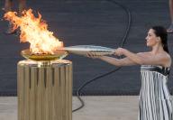 (240427) -- ATHENS, April 27, 2024 (Xinhua) -- Actress Mary Mina, playing the role of the High Priestess, lights the torch with the Olympic Flame during the handover ceremony of the Olympic Flame for the Paris 2024 Summer Games at Panathenaic stadium in Athens, Greek, April 26, 2024. (Xinhua\/Marios Lolos) - Marios Lolos -\/\/CHINENOUVELLE_CHINENOUVELLE0369\/Credit:CHINE NOUVELLE\/SIPA