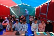 (240503) -- GAZA, May 3, 2024 (Xinhua) -- Palestinian students attend a class at a tent school in the southern Gaza Strip city of Rafah, on April 30, 2024. Now being displaced to the southernmost Gazan city of Rafah, Nihad Badreia, a Palestinian teacher, established a "tent school" for about 600 school-age children living in a refugee camp, as the current Palestinian-Israeli conflict has deprived students of their studies for nearly seven months. (Photo by Rizek Abdeljawad\/Xinhua) TO GO WITH Feature: Displaced teachers establish "tent school" for students in Rafah - Rizek Abdeljawad -\/\/CHINENOUVELLE_CnyztpE007010_20240504_PEPFN0A001\/Credit:CHINE NOUVELLE\/SIPA