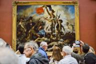 Visitors or tourists stands front of the Restored painting the Liberty Leading the People by the French artist painter Eugene Delacroix at the Mollien room section. Visit by night of the iconic rooms Denon and Mollien end States room at the Louvre museum Paris, FRANCE-04\/05\/2024.\/\/FRANCOLONXAVIER_xfrancolonLouvreMuseum003\/Credit:Xavier Francolon\/SIPA