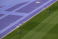 (240508) -- PARIS, May 8, 2024 (Xinhua) -- Workers mow the grass on the pitch of the Stade de France, in Paris, France, on May 7, 2024. (Xinhua\/Xu Zijian) - Xu Zijian -\/\/CHINENOUVELLE_CHINENOUVELLE0159\/Credit:CHINE NOUVELLE\/SIPA