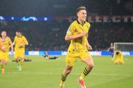 Dortmund\'s German defender Nico Schlotterbeck and teammates celabrate victory as PSG\'s players (background) collapse on the field at the final whistle during the UEFA Champions League semi-final second leg football match between Paris Saint-Germain (PSG) and Borussia Dortmund, at Parc des Princes stadium in Paris, FRANCE - 07\/04\/2024.\/\/JEE_psgdor.01\/Credit:J.E.E\/SIPA