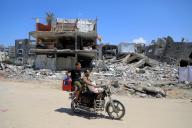 (240513) -- GAZA, May 13, 2024 (Xinhua) -- People pass destroyed buildings in the southern Gaza Strip city of Khan Younis, on May 13, 2024. The Palestinian death toll from the ongoing Israeli attacks on the Gaza Strip has risen to 35,091, health authorities in the Palestinian enclave said in a press statement on Monday. (Photo by Rizek Abdeljawad/Xinhua) - Rizek Abdeljawad -//CHINENOUVELLE_CnyztpE007013_20240514_PEPFN0A001/Credit:CHINE NOUVELLE/SIPA