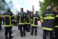 French firefighters hold flares and CGT union flags during a nationwide protest and strike day called by all the firefighter unions, to ask for an increase in the firefighters