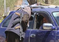 (240518) -- BAMYAN, May 18, 2024 (Xinhua) -- An Afghan security force member checks a vehicle following a shooting attack that killed three Spanish nationals on the previous day in Bamyan City, central Afghanistan\