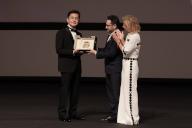 Goro Miyazaki (L) receives the award from jury member Juan Antonio Bayona (C) and president of the festival Iris Knobloch (R) during the ceremony for the Palme D