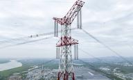 (240603) -- WUHU, June 3, 2024 (Xinhua) -- An aerial drone photo taken on April 10, 2024 shows electrical workers inspecting a power transmission line in Jiujiang District of Wuhu City, east China