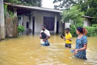 (240603) -- COLOMBO, June 3, 2024 (Xinhua) -- Residents wade through a flooded street after heavy rains on the outskirts of Colombo, Sri Lanka, on June 3, 2024. Sri Lanka