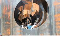 Visitors view "Labyrinth", an experimental metal maze installation in Genk, Belgium, on Sept. 26, 2016. With the weight of 186 tons and walls of up to five metres in height, the maze was opened for public visit from July 2015 to September 2016. (...