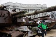 A woman and her child look at destroyed Russian tanks on display in central Kyiv. Russian troops entered Ukrainian territory on February 24, 2022, starting a conflict that has provoked destruction and a humanitarian crisis. (Photo by Oleksii Chumachenko / SOPA Images/Sipa USA