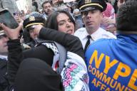 Members of the New York City Police Department arrest Nerdeen Kiswani, organizer of the pro-Palestine activism group, "Within Our Lifetime." Pro-Palestine demonstrators rallied in Manhattan, New York City condemning the Israel Defense Forces