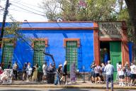 Visitors wait in line outside The Frida Kahlo Blue House Museum. The Frida Kahlo Blue House Museum, located in Mexico City, is the former home of the renowned artist Frida Kahlo. It offers visitors a glimpse into Kahlo